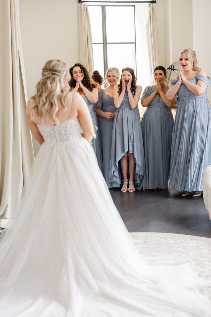 Rochester wedding photographer capturing a documentary first look moment with a bride and her bridesmaids.