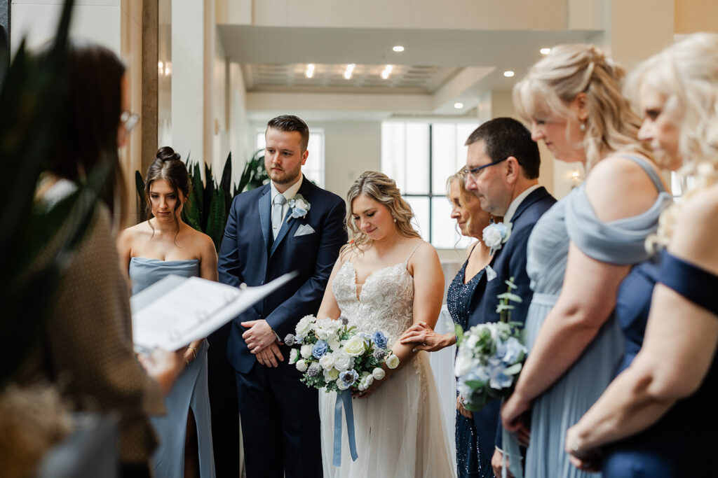 Rochester wedding photographer capturing a documentary prayer circle in memory of late family members.